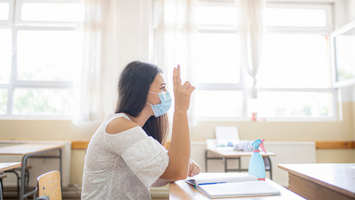 Student using a mask while in the classroom during the pandemic